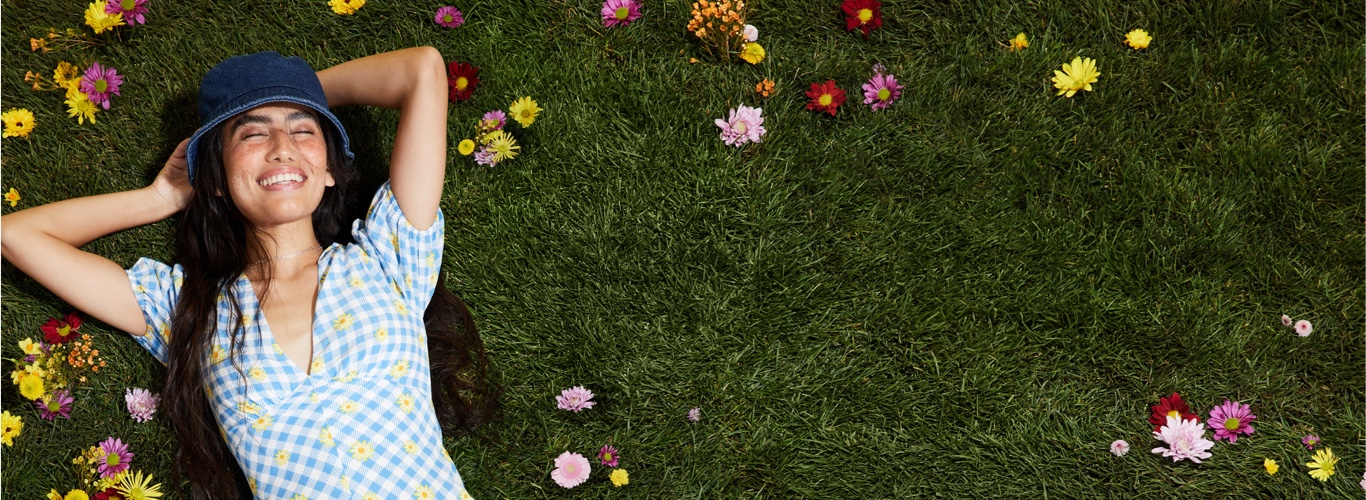 image of green grass and flowers. women enjoying the sunshine